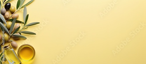 Photo of olives and olive oil on a vibrant yellow background with copy space with copy space