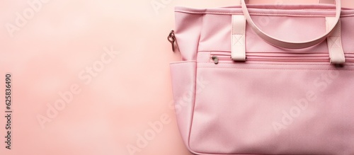 Photo of a pink purse hanging on a pink wall, with plenty of space for your own message or design with copy space