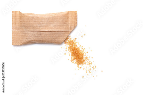 Obraz na plátně Spilled cane sugar from a small paper sachet