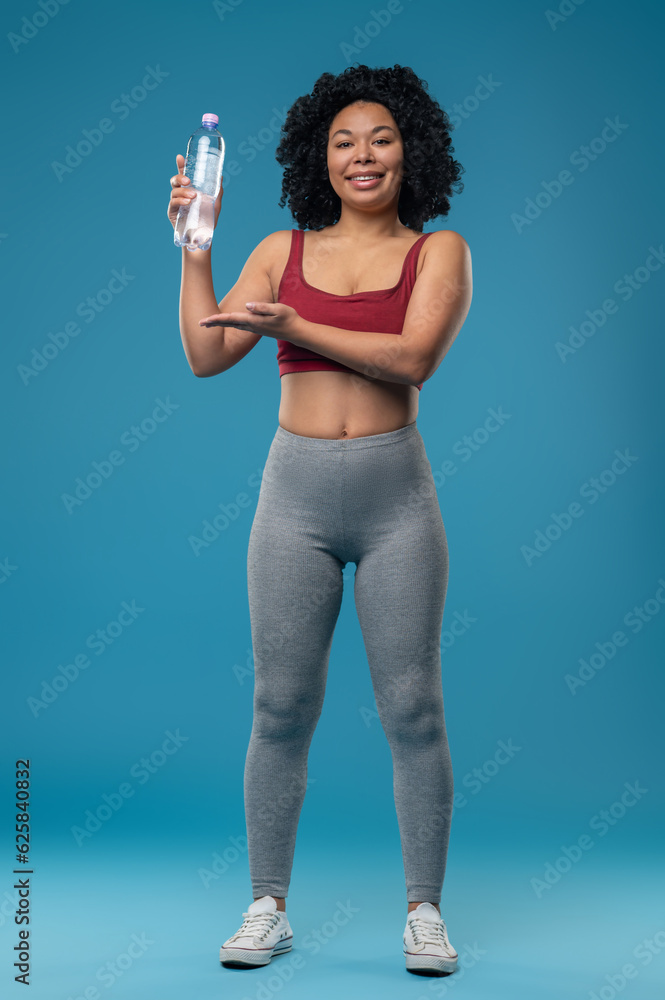 Sporty woman in sportswear with a bottle of water Sporty woman in sportswear with a bottle of water