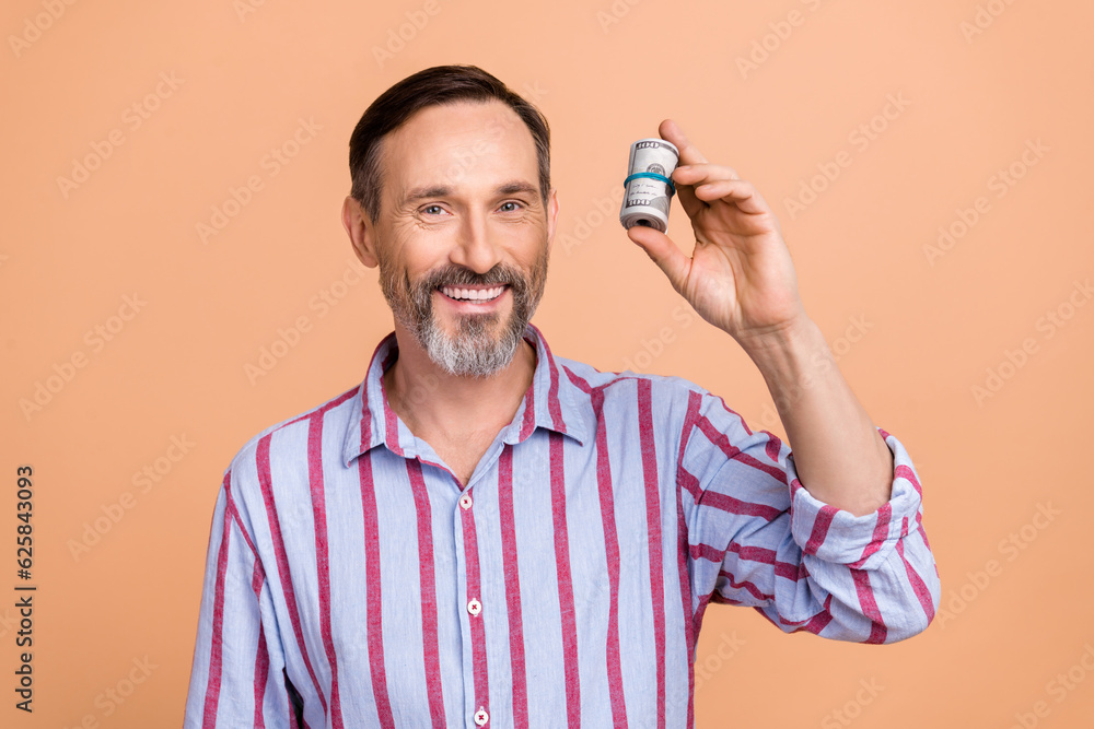 Portrait of satisfied successful person with white gray beard wear stylish shirt holding dollars isolated on pastel color background Portrait of satisfied successful person with white gray beard wear stylish shirt holding dollars isolated on pastel color background