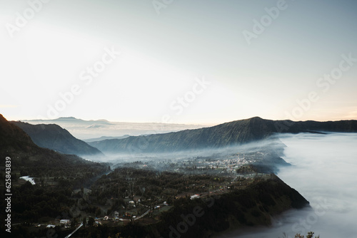Cemoro Lawang village near Gunung Bromo or Mount Bromo is covered by clouds at dawn viewed from Seruni Sunrise Point © David