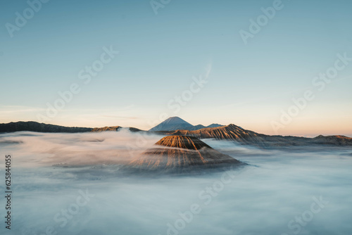 Gunung Bromo or Bromo Mountain is covered by clouds in the morning with clear blue sky © David