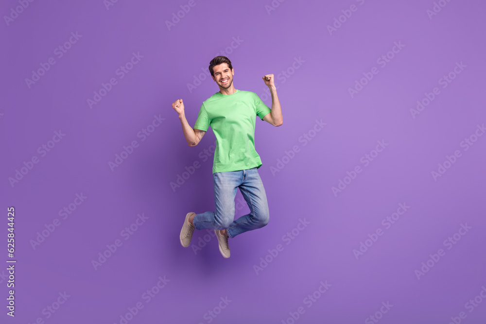 Full body length photo of crazy funny man jump celebration hooray crazy fan good victory football team isolated on violet color background Full body length photo of crazy funny man jump celebration hooray crazy fan good victory football team isolated on violet color background