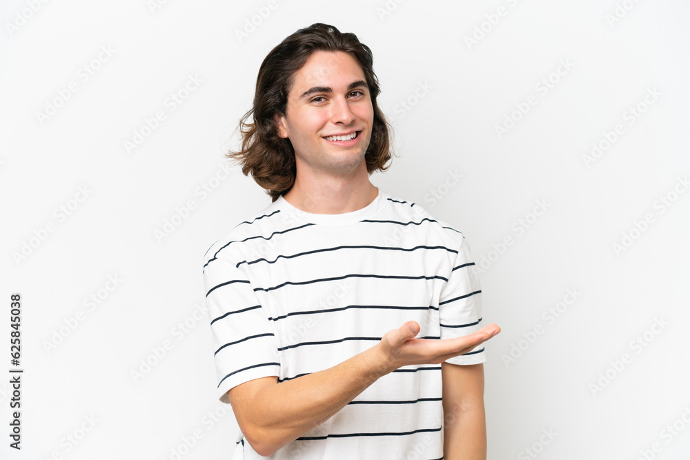 Young handsome man isolated on white background presenting an idea while looking smiling towards Young handsome man isolated on white background presenting an idea while looking smiling towards
