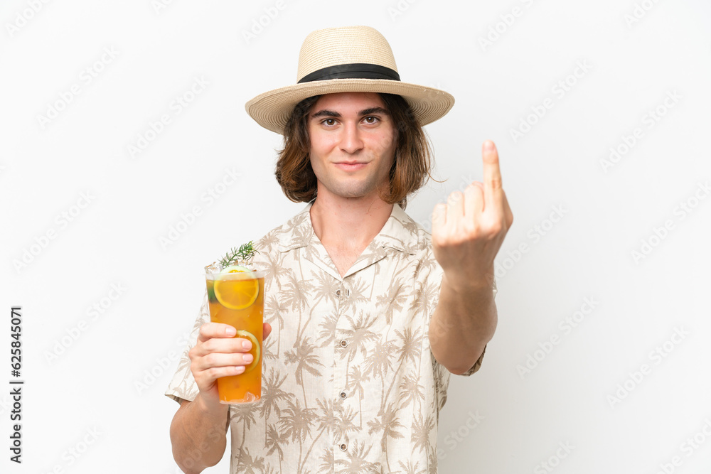 Young handsome man holding a cocktail isolated on white background doing coming gesture Young handsome man holding a cocktail isolated on white background doing coming gesture