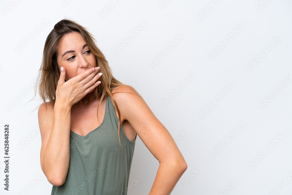 Young caucasian woman isolated on white background doing surprise gesture while looking to the side Young caucasian woman isolated on white background doing surprise gesture while looking to the side