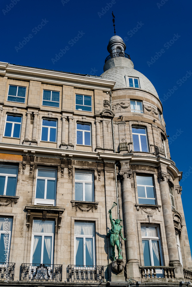 Historical building with a sculpture  along the waterfront in the old city centre, Antwerp, BelgiumAntwerp, Belgium