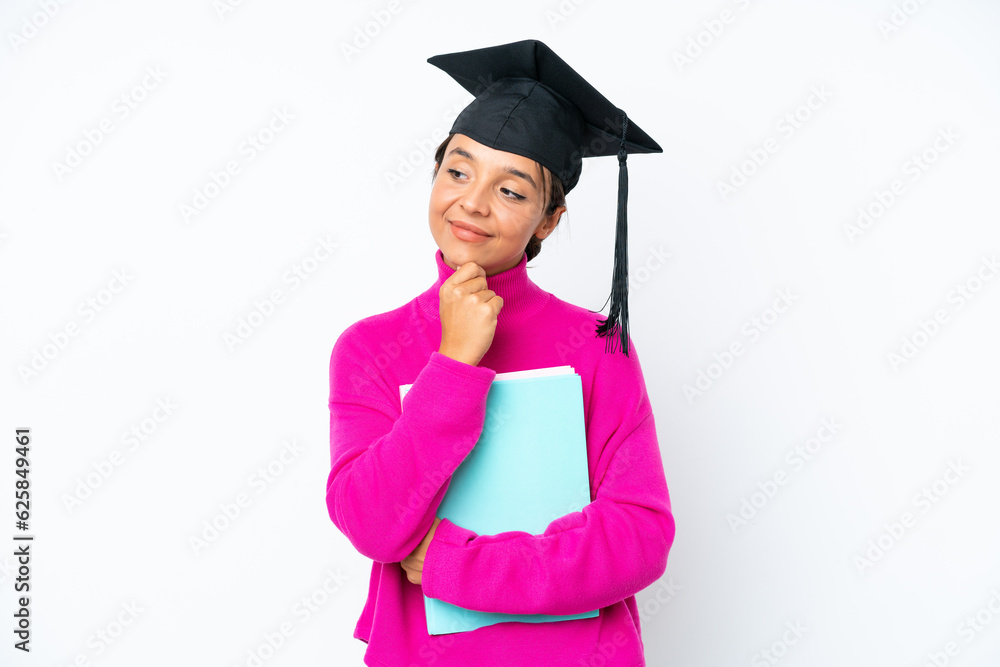 Young student hispanic woman holding a books isolated on white background looking up while smiling Young student hispanic woman holding a books isolated on white background looking up while smiling