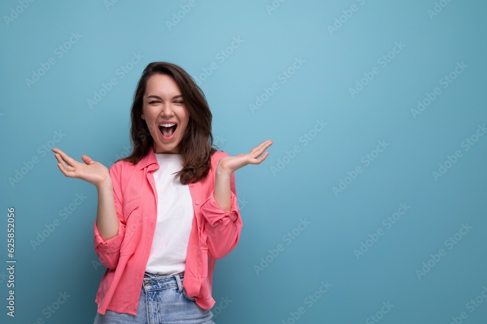 happy lucky brunette woman in informal look rejoices on studio background happy lucky brunette woman in informal look rejoices on studio background