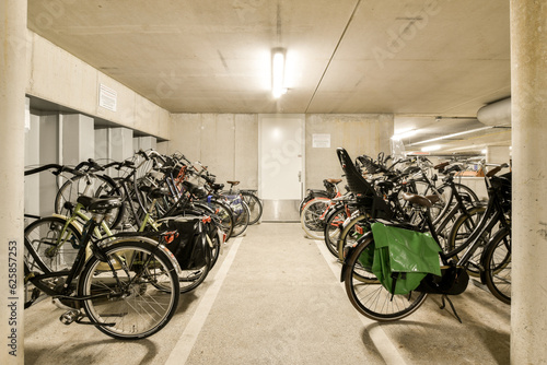 Obraz na plátně several bikes parked in a parking space with no one on the ground, and there is