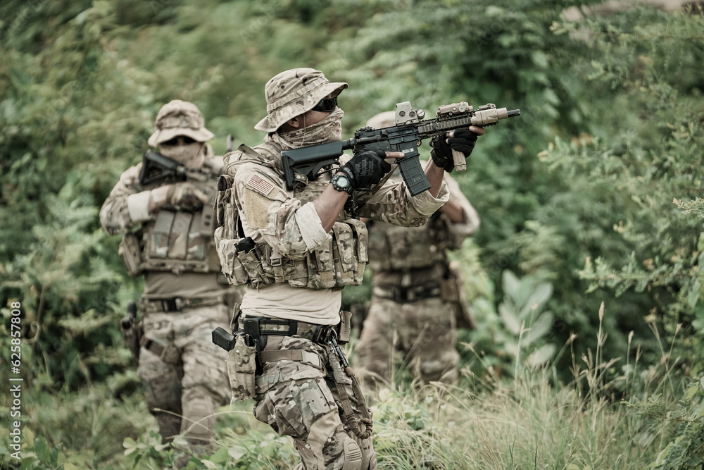 United States Army ranger during the military operation. Professional marine soldiers training with weapon on a military range. United States Army ranger during the military operation. Professional marine soldiers training with weapon on a military range.