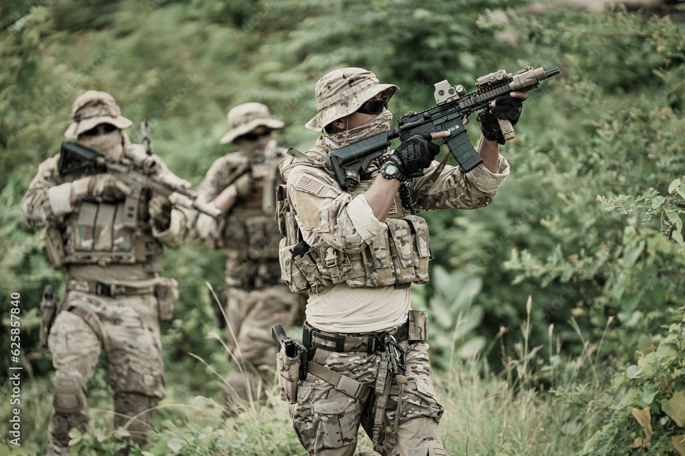 Fototapeta premium United States Army ranger during the military operation. Professional marine soldiers training with weapon on a military range.