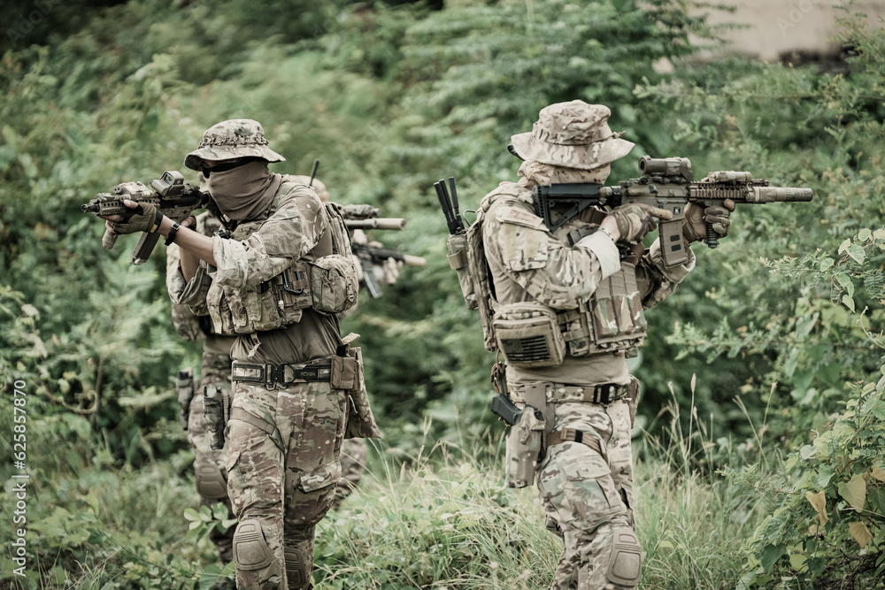 United States Army ranger during the military operation. Professional marine soldiers training with weapon on a military range. United States Army ranger during the military operation. Professional marine soldiers training with weapon on a military range.