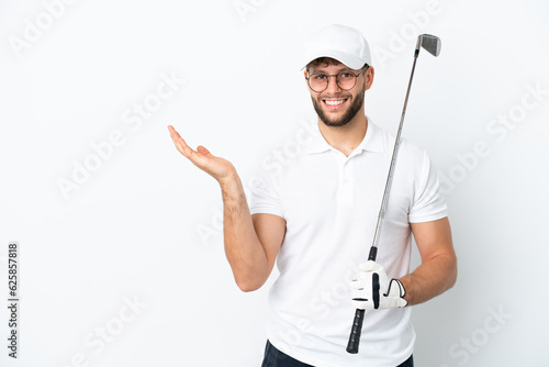 Handsome young man playing golf isolated on white background extending hands to the side for inviting to come