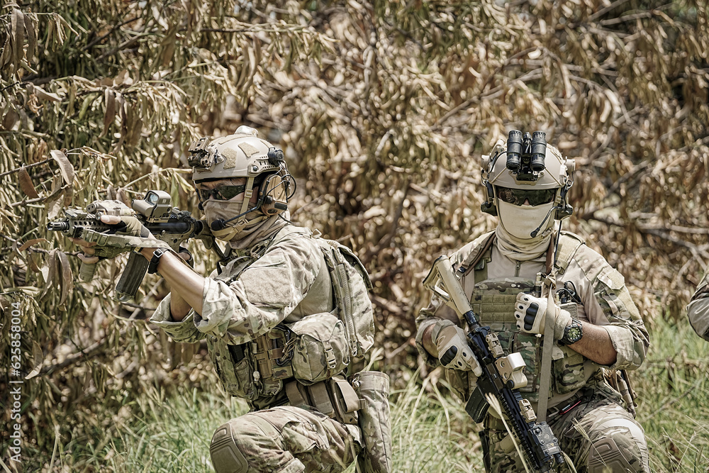 United States Army ranger during the military operation. Professional marine soldiers training with weapon on a military range. United States Army ranger during the military operation. Professional marine soldiers training with weapon on a military range.