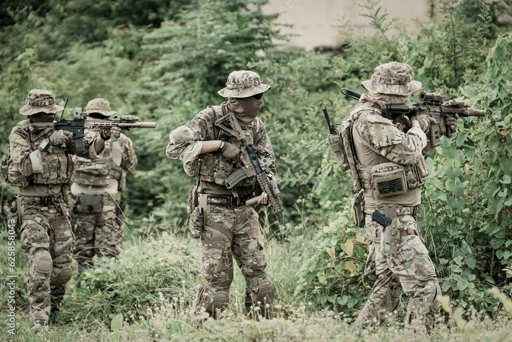 United States Army ranger during the military operation. Professional marine soldiers training with weapon on a military range. United States Army ranger during the military operation. Professional marine soldiers training with weapon on a military range.