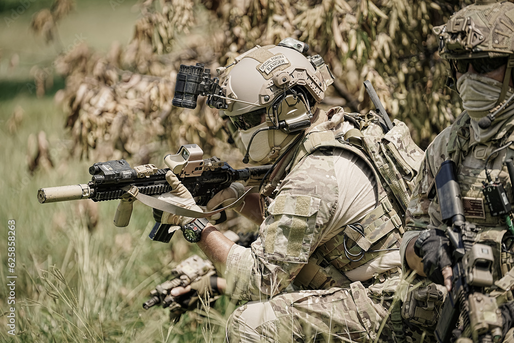United States Army ranger during the military operation. Professional marine soldiers training with weapon on a military range. United States Army ranger during the military operation. Professional marine soldiers training with weapon on a military range.