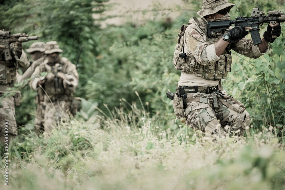 United States Army ranger during the military operation. Professional marine soldiers training with weapon on a military range.