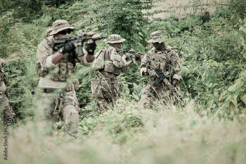 United States Army ranger during the military operation. Professional marine soldiers training with weapon on a military range.