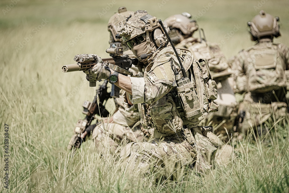 United States Army ranger during the military operation. Professional marine soldiers training with weapon on a military range. United States Army ranger during the military operation. Professional marine soldiers training with weapon on a military range.