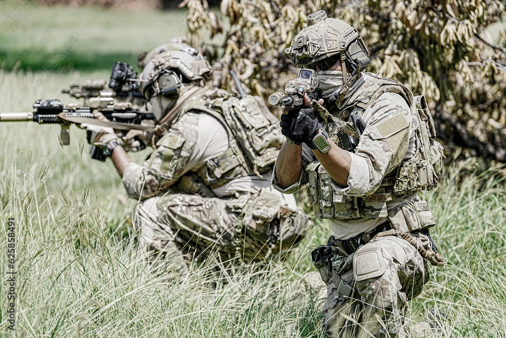 United States Army ranger during the military operation. Professional marine soldiers training with weapon on a military range. United States Army ranger during the military operation. Professional marine soldiers training with weapon on a military range.