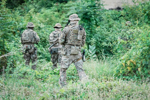 United States Army ranger during the military operation. Professional marine soldiers training with weapon on a military range.