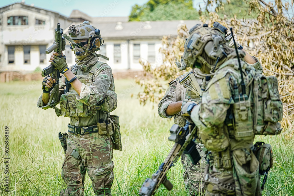 Fototapeta premium United States Army ranger during the military operation. Professional marine soldiers training with weapon on a military range.