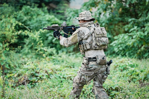 United States Army ranger during the military operation. Professional marine soldiers training with weapon on a military range.