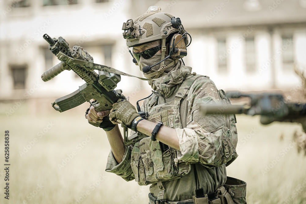 United States Army ranger during the military operation. Professional marine soldiers training with weapon on a military range. United States Army ranger during the military operation. Professional marine soldiers training with weapon on a military range.