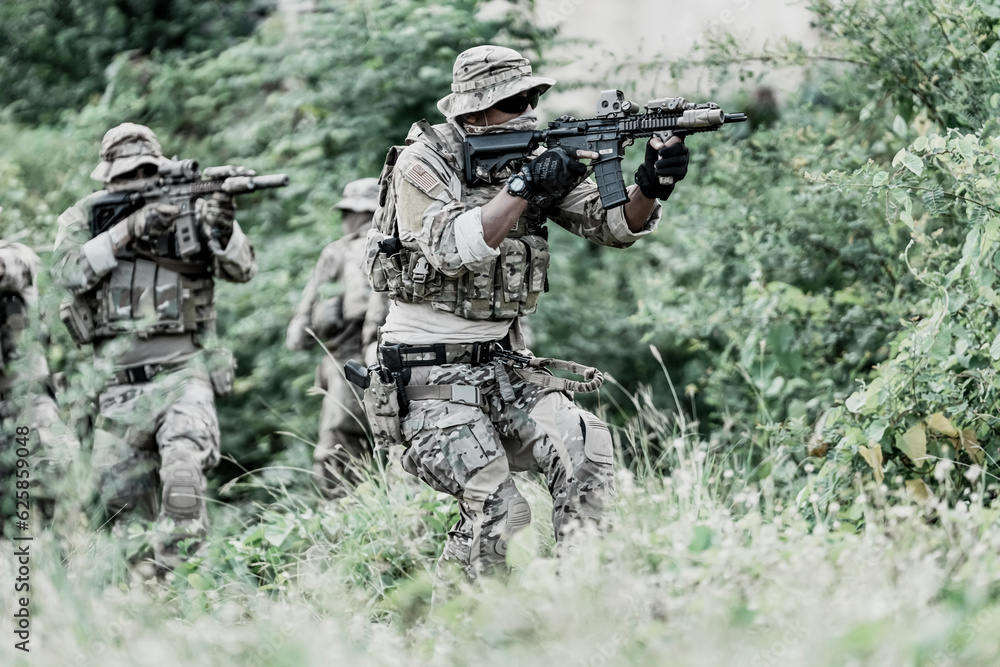 United States Army ranger during the military operation. Professional marine soldiers training with weapon on a military range. United States Army ranger during the military operation. Professional marine soldiers training with weapon on a military range.