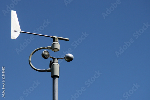 Weather station instruments against blue sky background photo