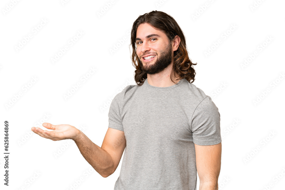 Young handsome man over isolated chroma key background presenting an idea while looking smiling towards Young handsome man over isolated chroma key background presenting an idea while looking smiling towards