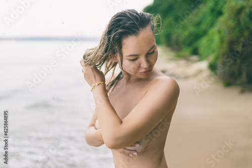 Portrait of beautiful nude blonde on the nudist beach photo