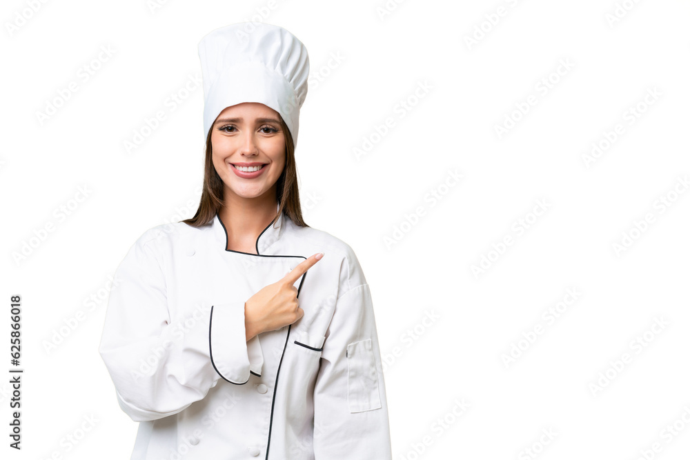 Young chef caucasian woman over isolated background pointing to the side to present a product Young chef caucasian woman over isolated background pointing to the side to present a product