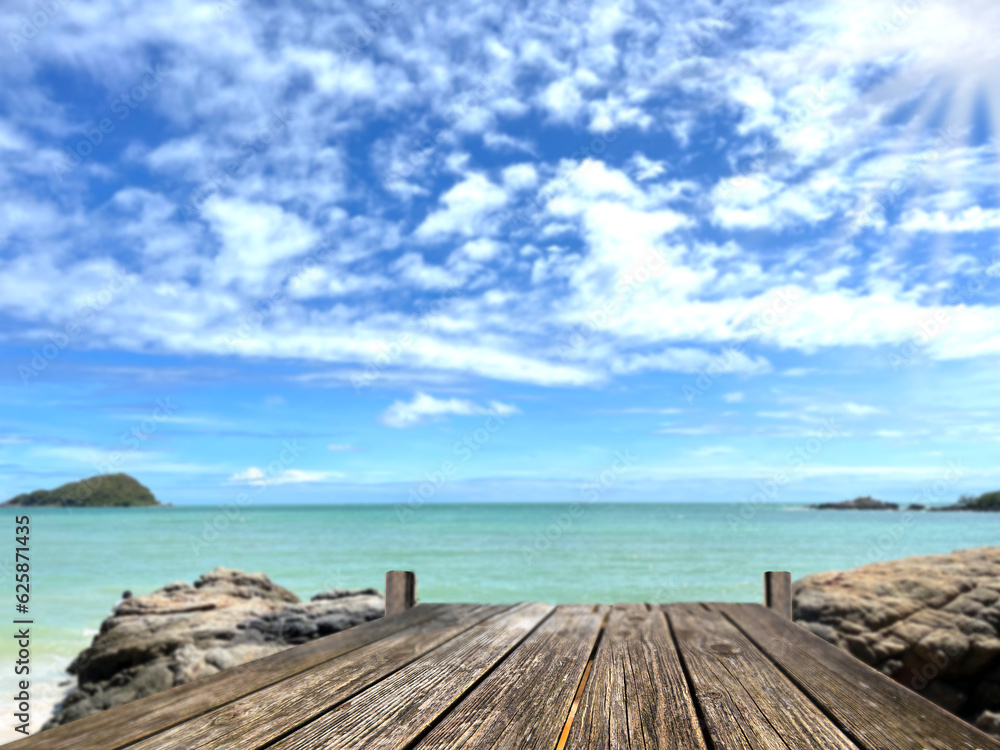 Wooden table, wooden bridge in blurred sea background