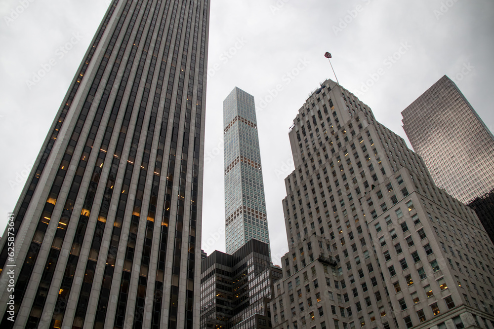 Fototapeta premium 432 Park Avenue visible between older New York skyscrapers, view from Central Park on a cloudy day.