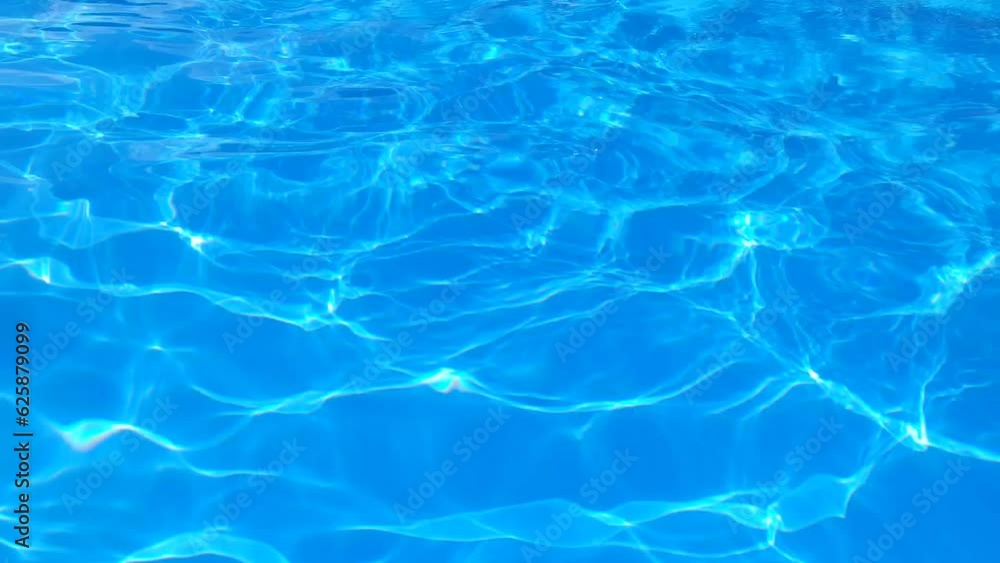 Blue water in the pool with sun glare. Blue water in the pool with sun glare.