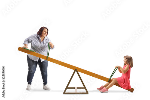 Woman lifting a daughter on a seesaw