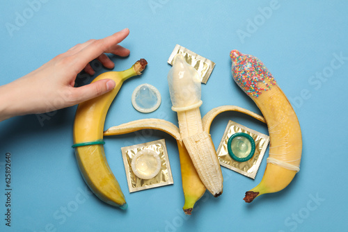 Condoms on bananas on a blue background
