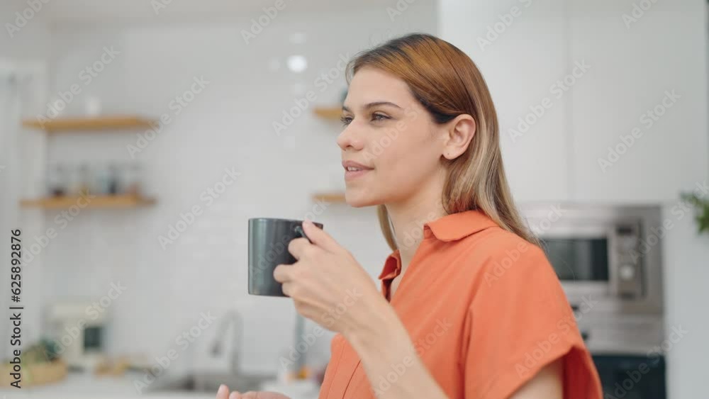 Lifestyle concept. Dreaming young woman enjoy drinking a cup of tea heaping or coffee in the morning at home. woman enjoying breakfast with a cup of coffee Lifestyle concept. Dreaming young woman enjoy drinking a cup of tea heaping or coffee in the morning at home. woman enjoying breakfast with a cup of coffee