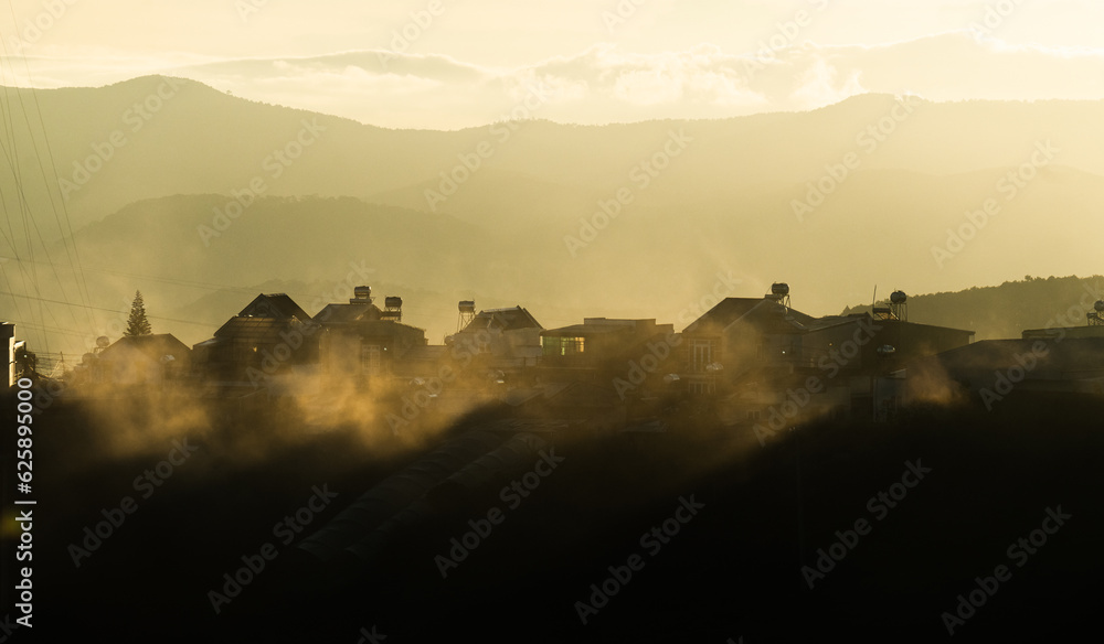 sunrise over the mountains with cloud in the town