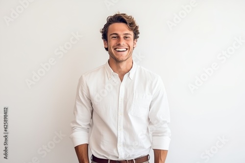 Portrait of handsome young man smiling and looking at camera on white background