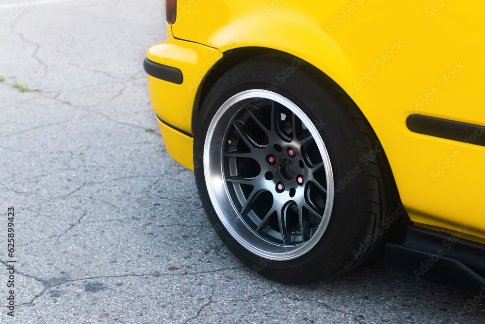 Lowrider custom stance stylish sports car closeup. Yellow car