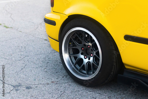 Lowrider custom stance stylish sports car closeup. Yellow car