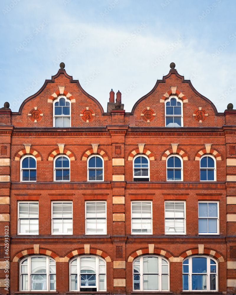 Dutch architecture merchant building in central London. Facade of a red brick Victorian property from 1893, in Dutch Baroque design with decorative gable roof.