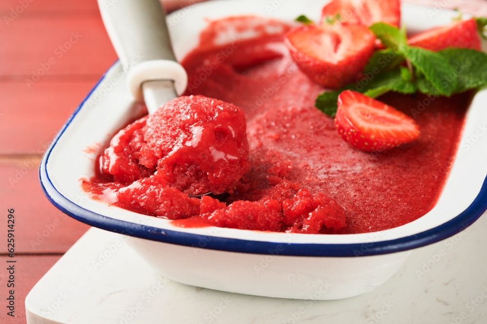Strawberry granita or fresh berry sorbet in white rustic bowl on old wooden table background. Ice cream with strawberry and mint. Summer treat. Top view. Strawberry granita or fresh berry sorbet in white rustic bowl on old wooden table background. Ice cream with strawberry and mint. Summer treat. Top view.