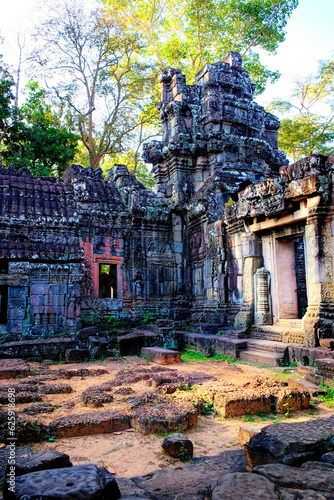 Photograph featuring the famous stone remnants of ancient temples located in the forests of Cambodia, Banteay Kdei.