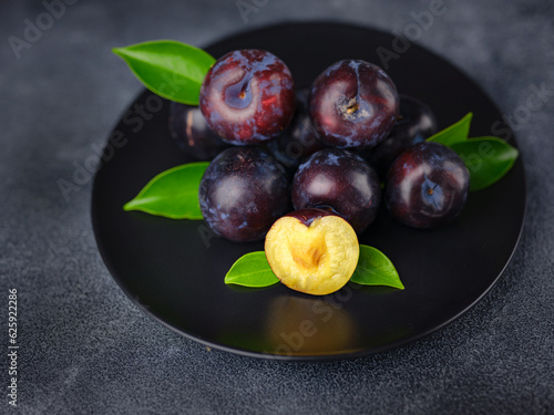 Sweet plums on dark background