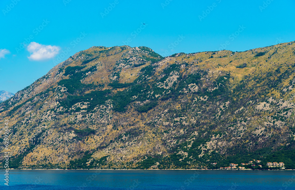 seascapes, a view of the Bay of Kotor during a cruise on a ship in Montenegro, a bright sunny day, mountains and coast, the concept of a summer trip